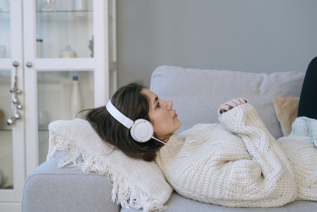 woman laying on the couch having anxiety