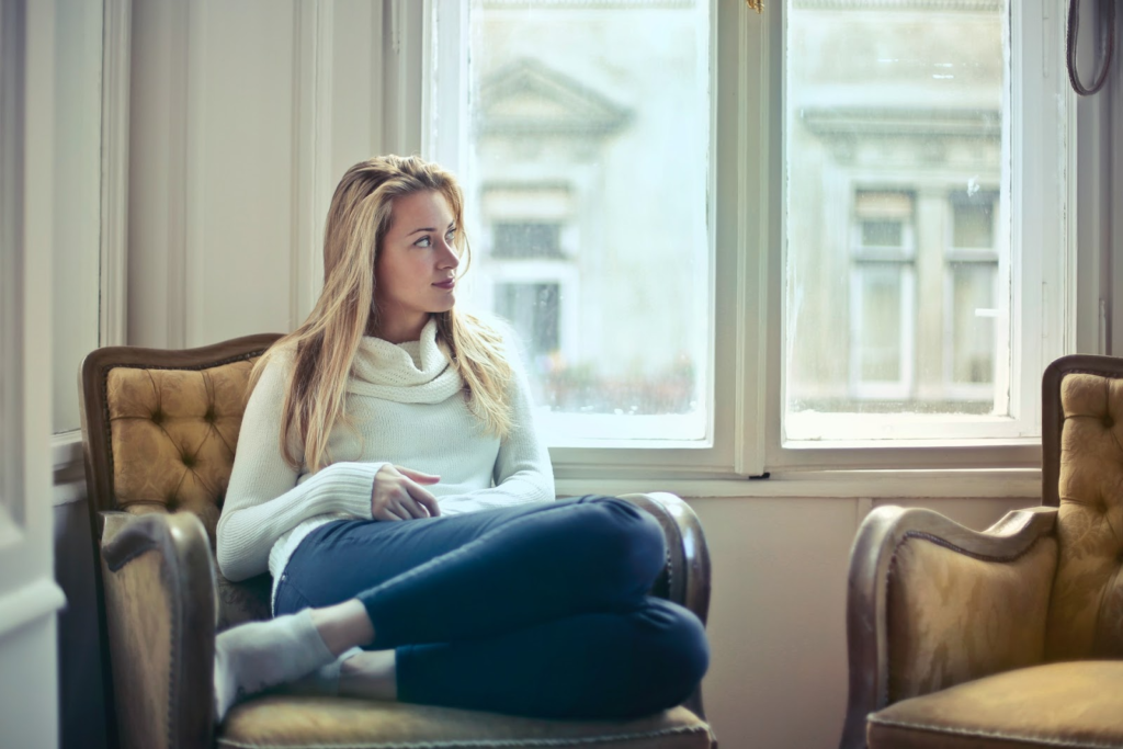 woman sitting in her chair looking out the window