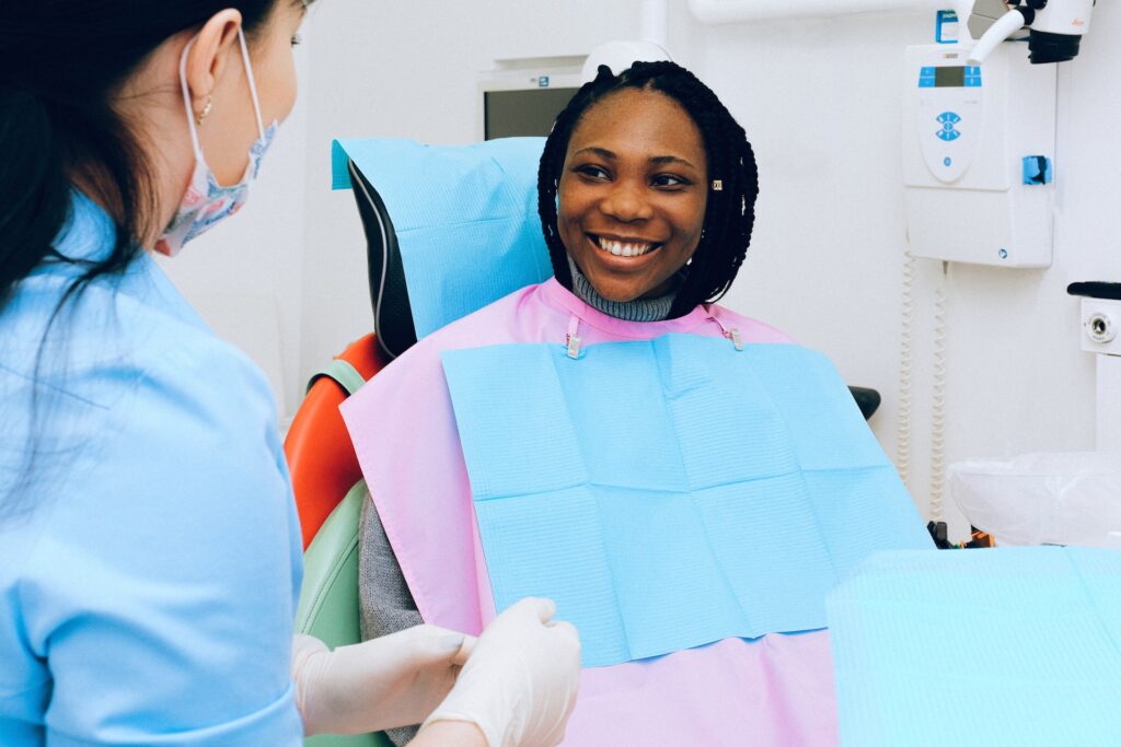 woman smiling while speaking to the dentist during her dental appointment